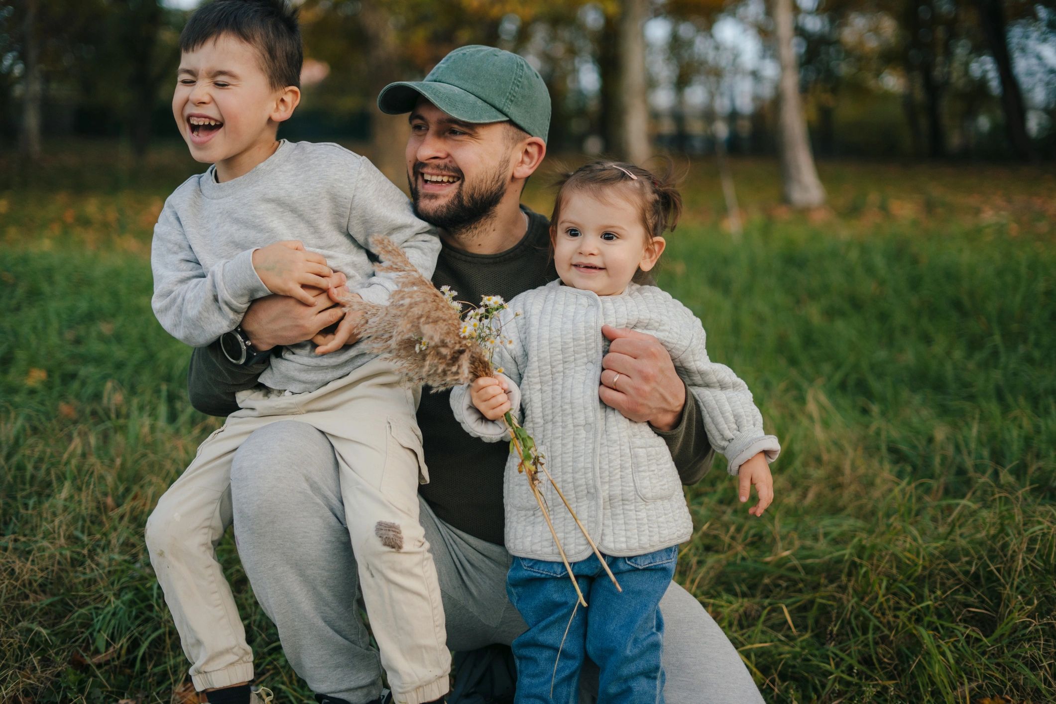 Father hugging kids outdoors